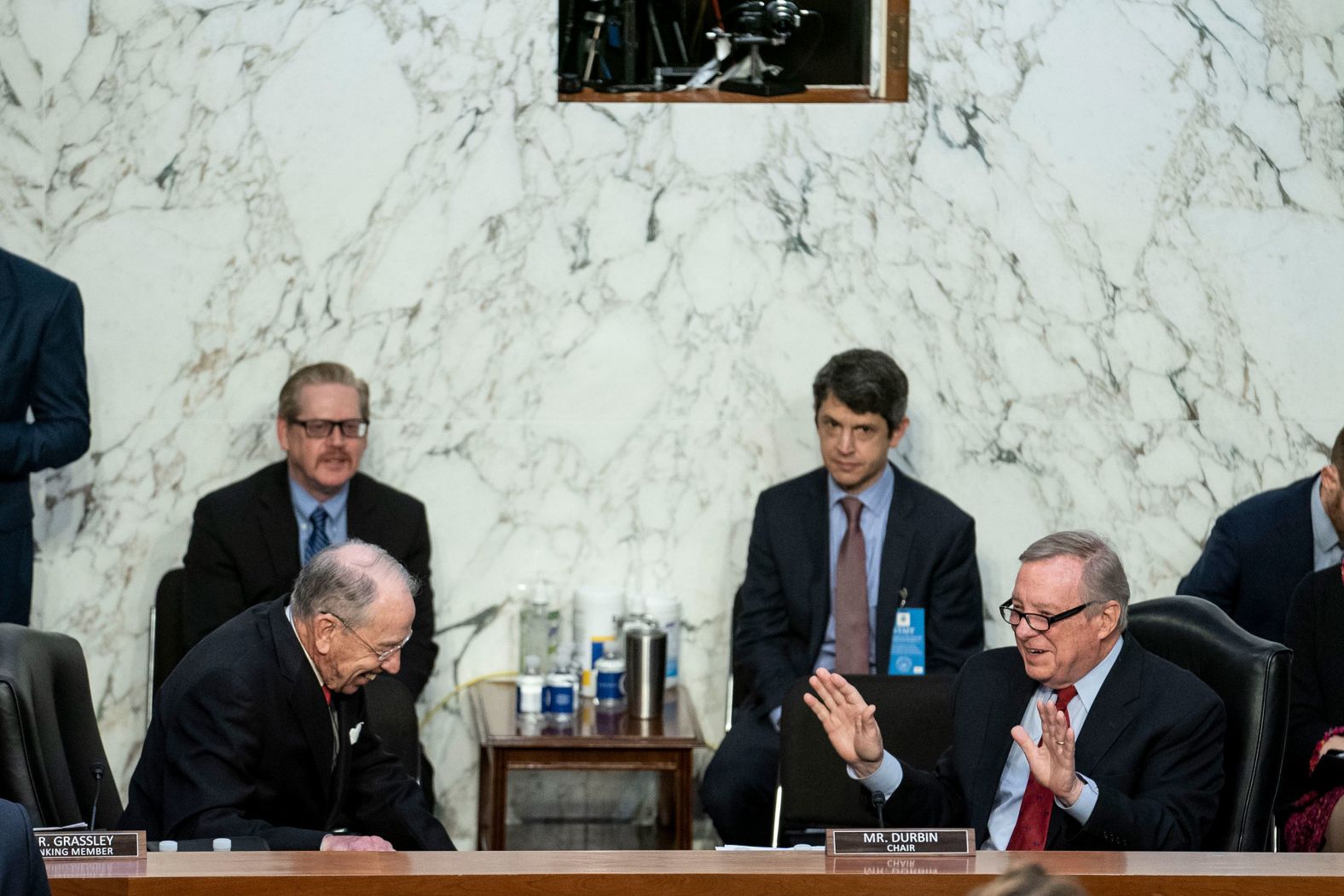 Durbin and Grassley laugh together before the start of proceedings on March 22.