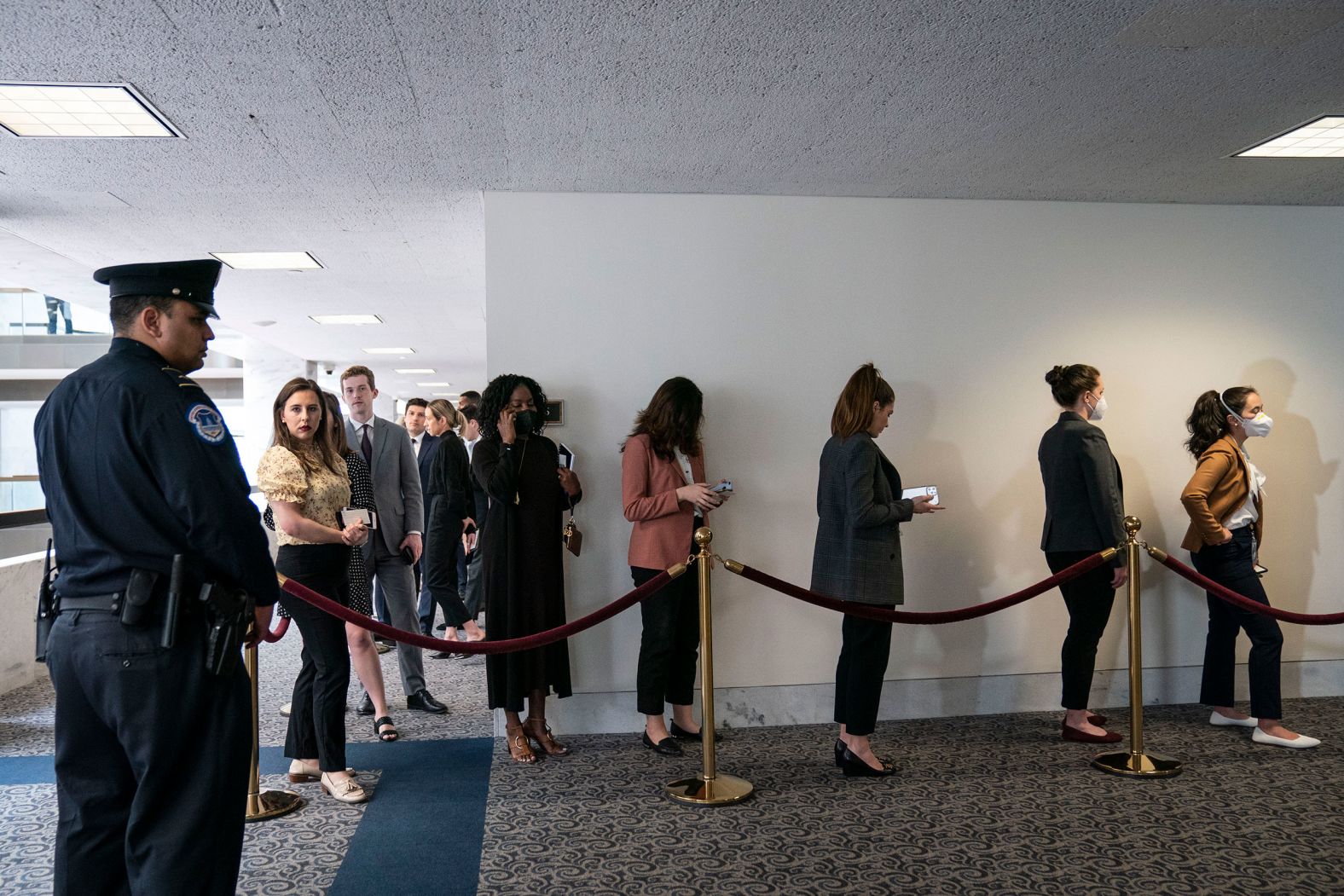 People wait in line for a chance to sit in during the hearing on March 22.