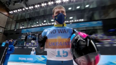 Vladyslav Heraskevych of Ukraine holds a sign with a message reading 'No war in Ukraine' during the Beijing 2022 Winter Olympics in February.