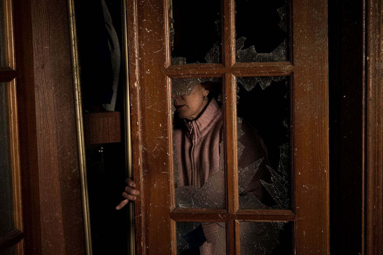 A woman cleans up a room Monday, March 21, in a building that was damaged by bombing in Kyiv, Ukraine.