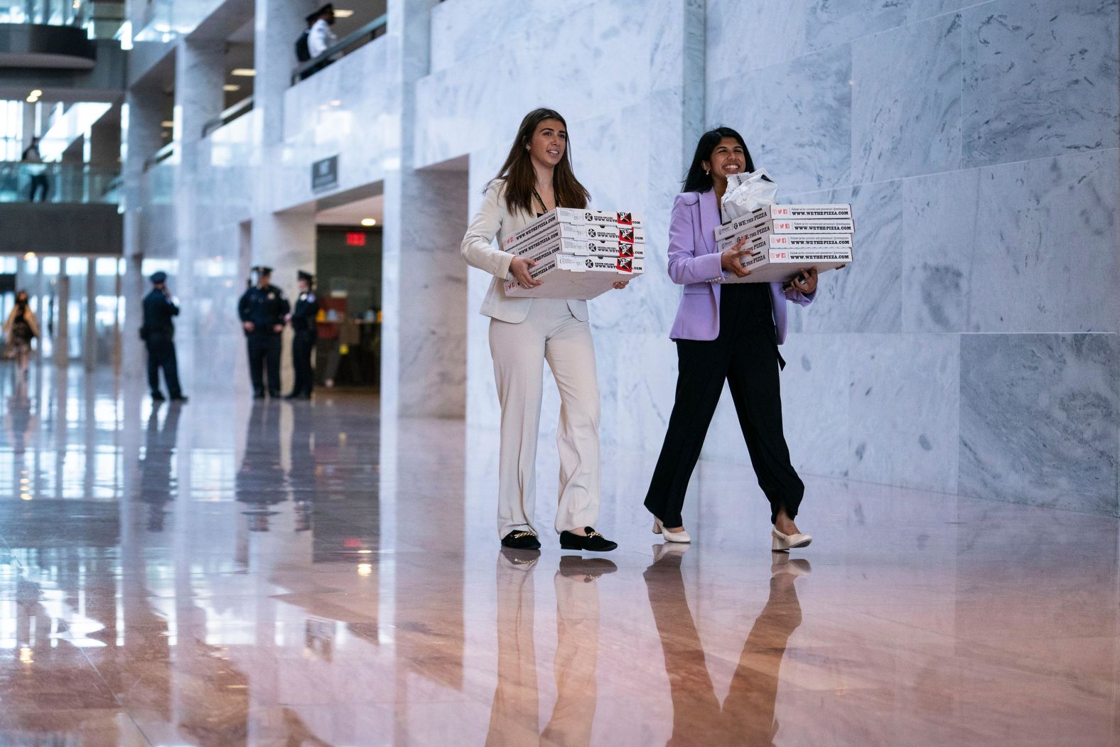 People carry pizza boxes on March 22 as the hearing stretched into the evening hours. "It's a fun cliche on Capitol Hill to take photos of the staffers carrying pizza boxes (almost always from We, The Pizza), but I still love it," Silbiger said. "It's the telltale sign that congresspeople and their staff will be on campus late for something historic."