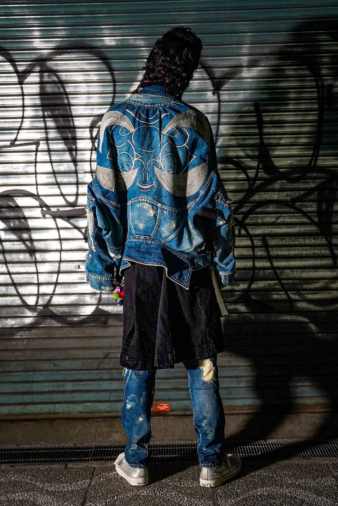 Daruma appear on a denim jacket by Maison Shun Ishizawa.
