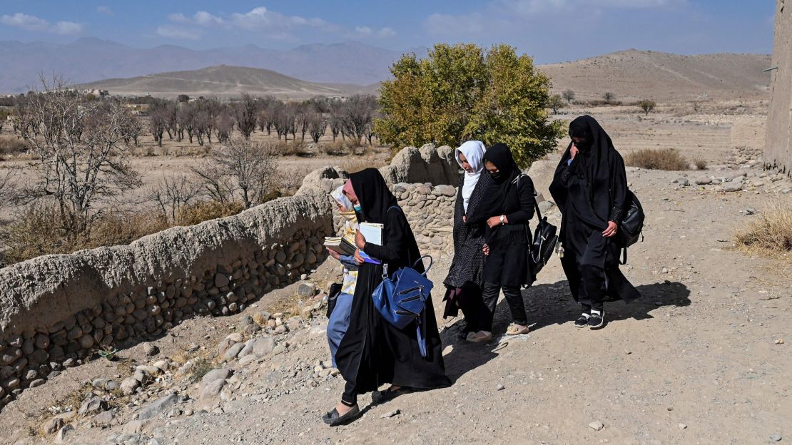 In this file photo, young women are seen returning home after school in the village of Jangalak.