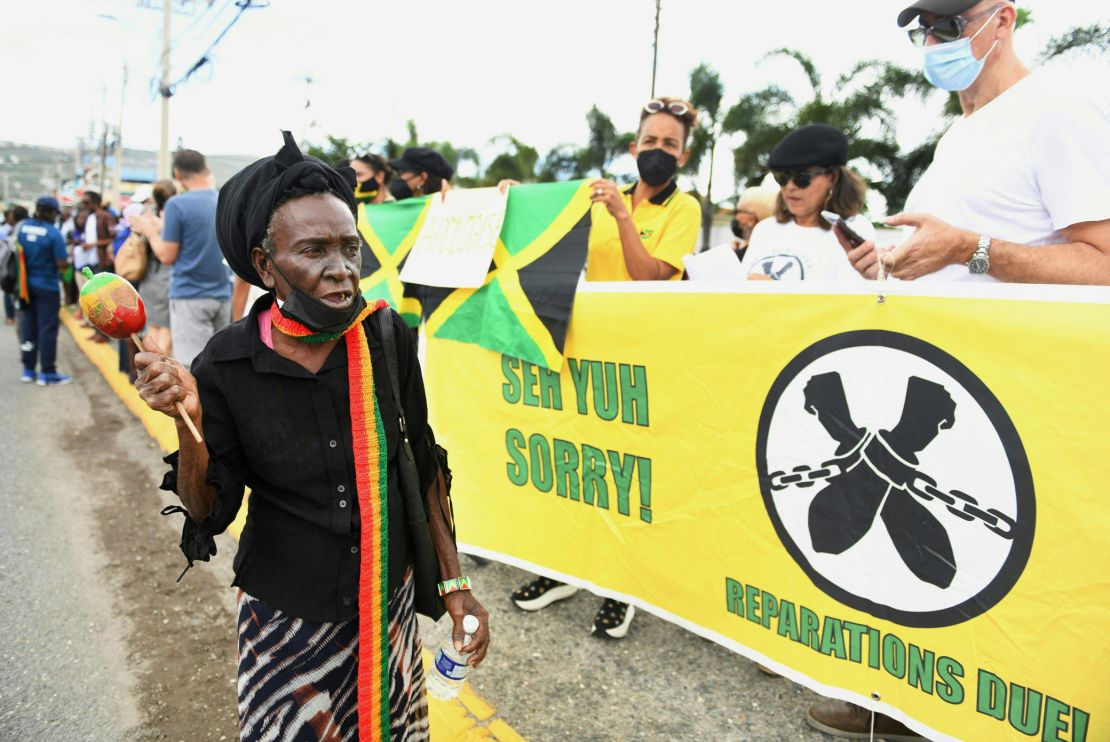 People call for slavery reparations outside the entrance of the British High Commission in Kingston, Jamaica on Tuesday.
