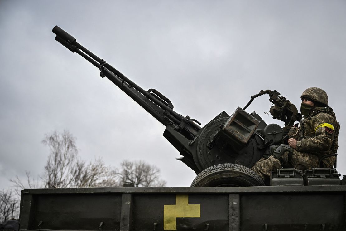 An Ukrainian soldier keeps position sitting on a ZU-23-2 anti-aircraft gun at a frontline northeast of Kyiv on March 3, 2022.