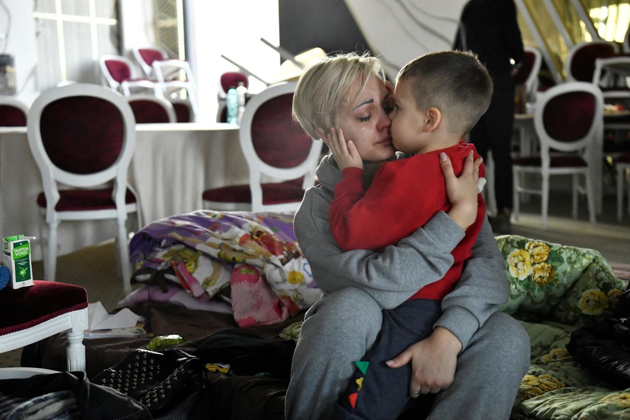 Helen Yakubets is comforted by her 5-year-old son, Egor, in a hotel ballroom that had been converted to a temporary shelter in Suceava, Romania, on March 20. Her 18-year-old son and husband stayed in Ukraine to fight. 