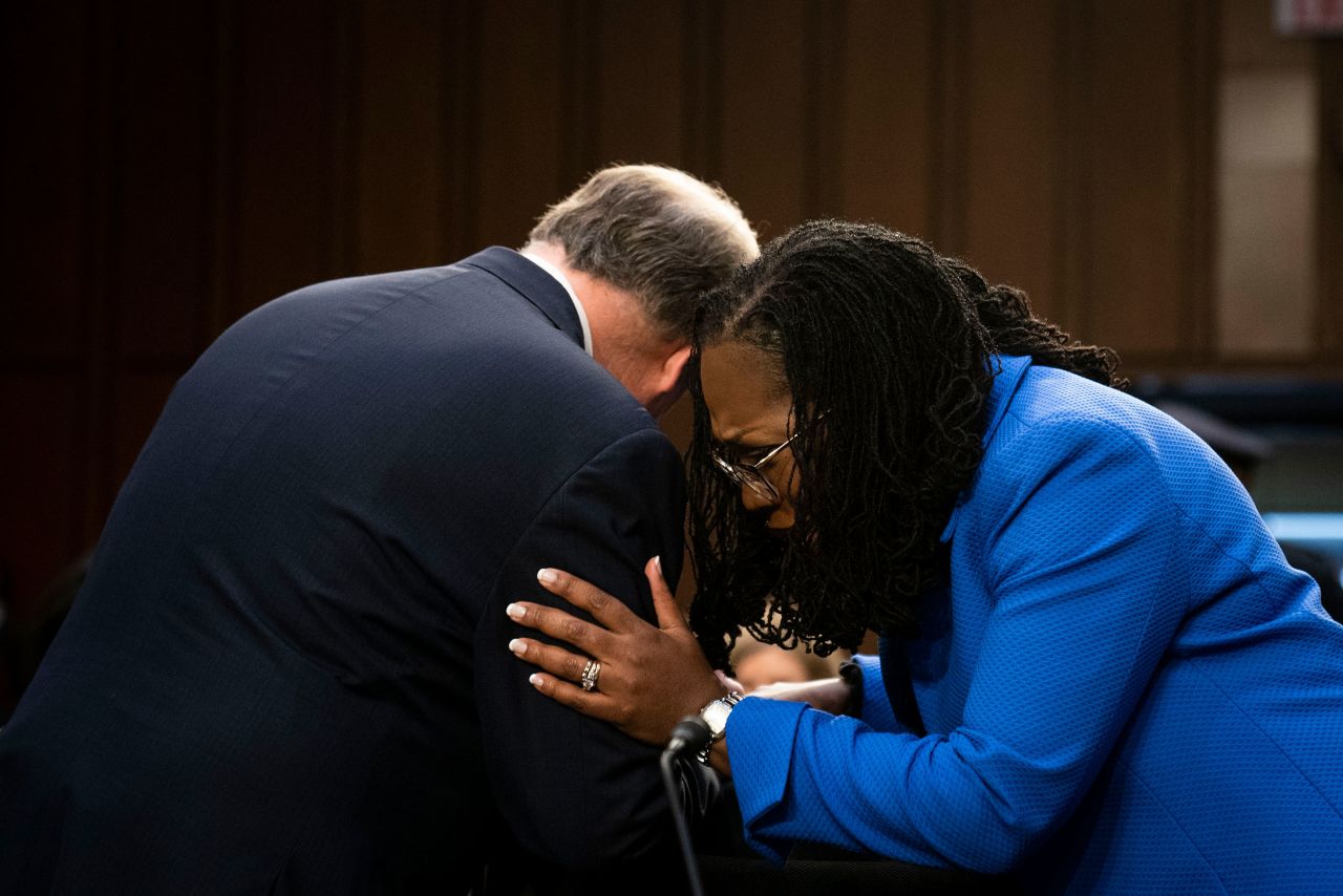 Jackson hugs former US Sen. Doug Jones on March 23. Jones had been advising Jackson during the hearings.