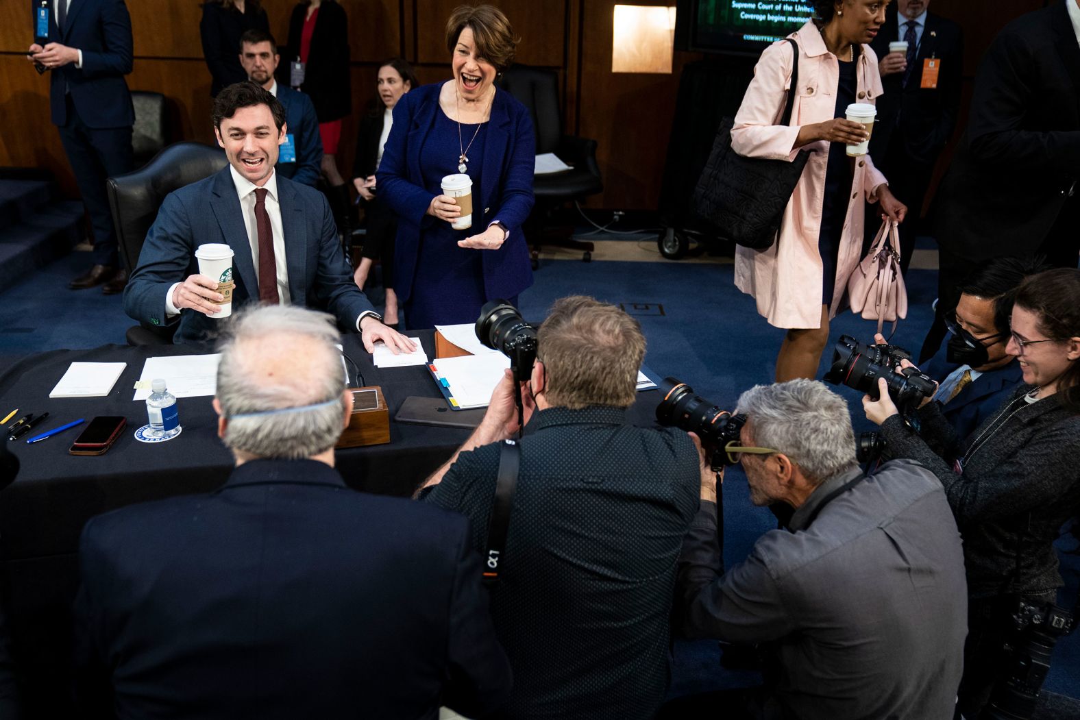 US Sens. Jon Ossoff and Amy Klobuchar joke with photographers ahead of the hearing on March 23. "It's a funny relationship to sit next to people for upwards of 12 hours without speaking," photographer Sarah Silbiger said. "We're always grateful when a lawmaker breaks the fourth wall to share a laugh."