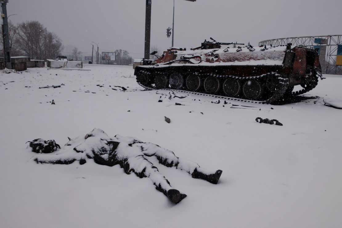 Snow covers the body of a dead Russian soldier near a highway outside Kharkiv, Ukraine, a day after the invasion began. 