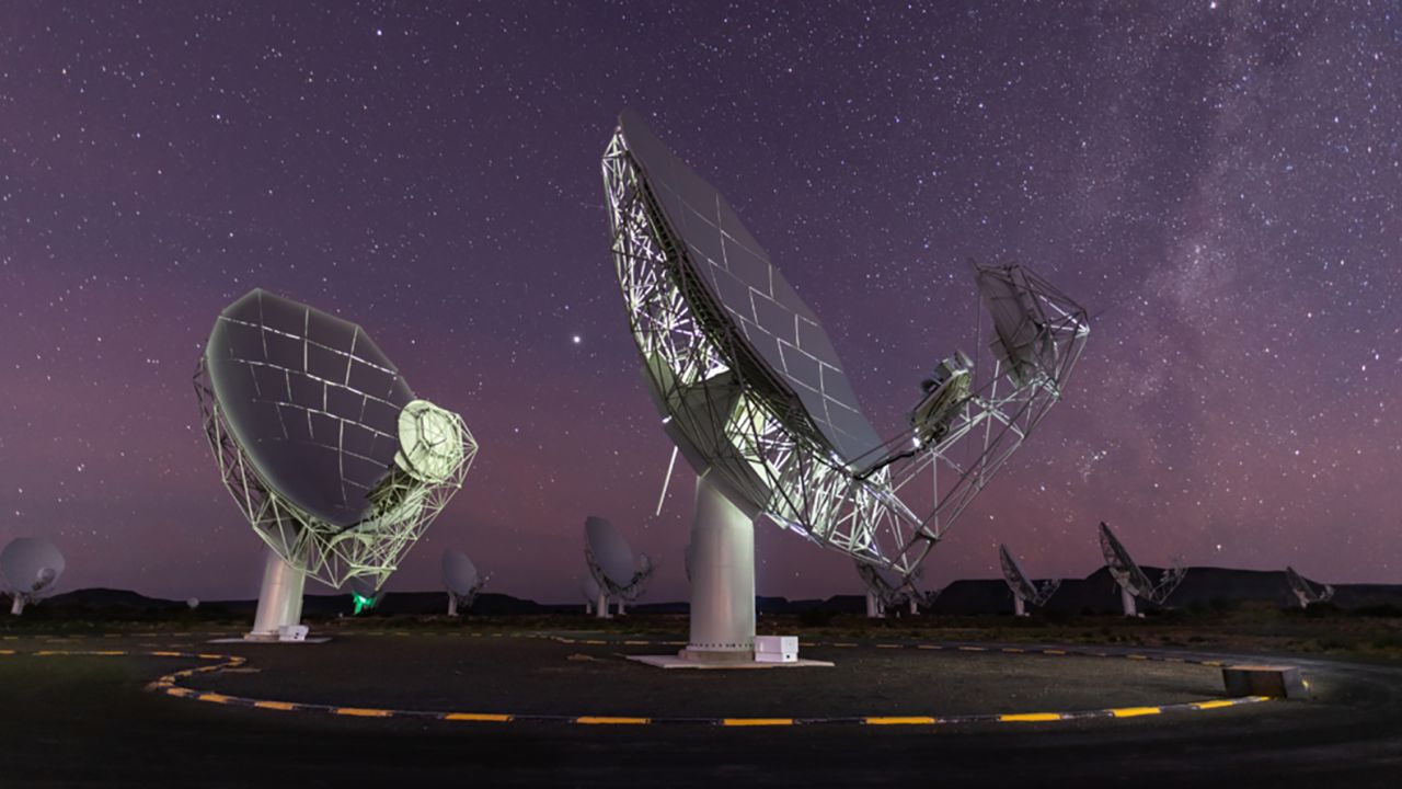The MeerKAT radio telescope dishes can be seen beneath a star-filled sky in Karoo, South Africa. 