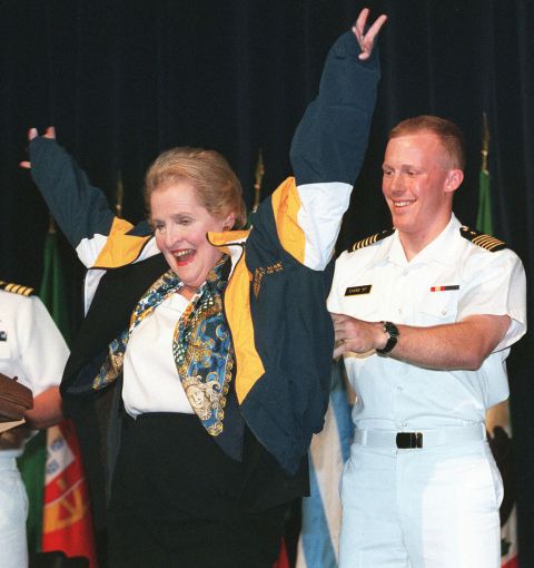 Albright puts on a jacket as she visits the US Naval Academy in 1997.
