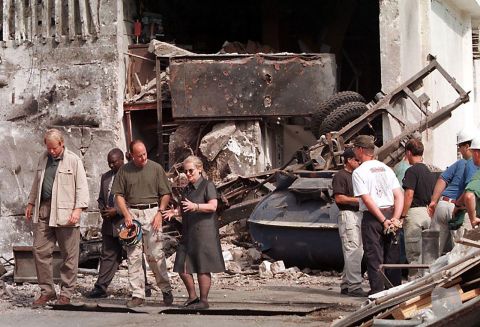 Albright talks with a member of the FBI while visiting the site where a US embassy was bombed in Dar es Salaam, Tanzania, in 1998.
