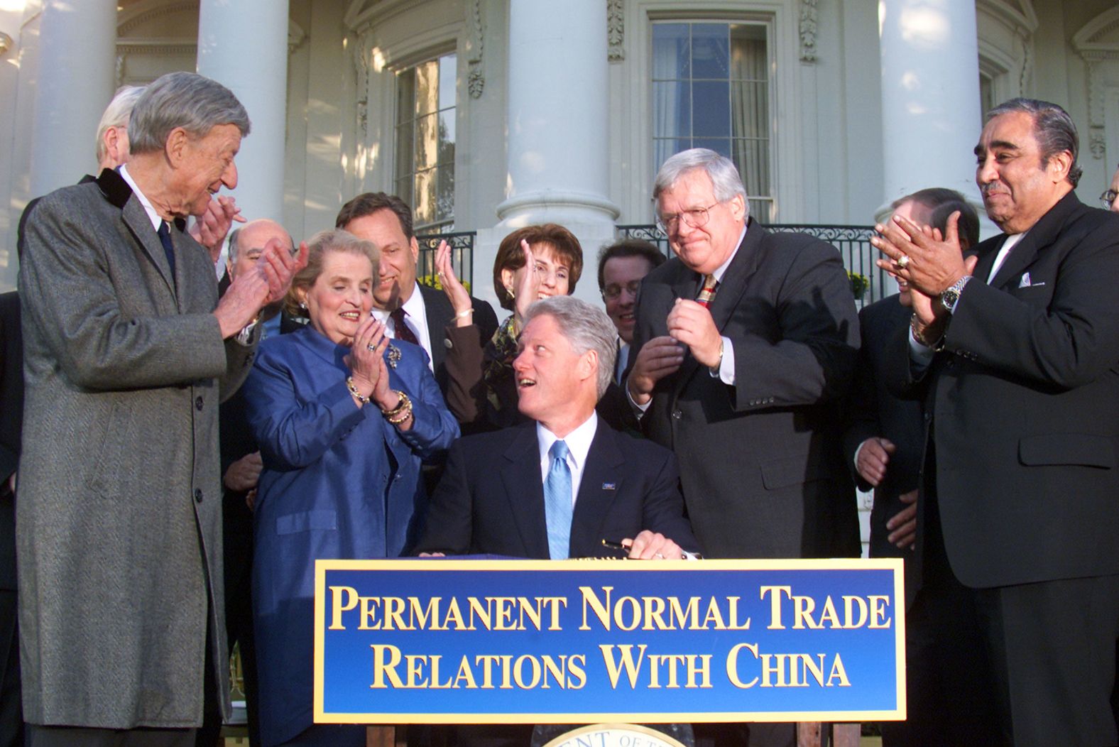 President Bill Clinton is surrounded by Albright and others in 2000 while signing bipartisan legislation normalizing trade relations with China.