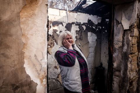 Svetlana Ilyuhina looks at the wreckage of her home in Kyiv following a Russian rocket attack on March 23. "First there was smoke, and then everything went black," she said.