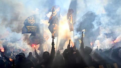 Nationalist activists light flares and shout anti-Russian slogans during a demonstration in front of President Volodymyr Zelensky's offices in Kyiv on October 14, 2020.