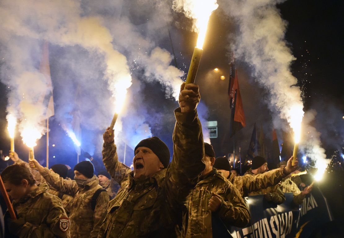 Members of the Azov regiment and veterans march with torches to celebrate Defender of Ukraine Day in Kyiv on October 14, 2016.
