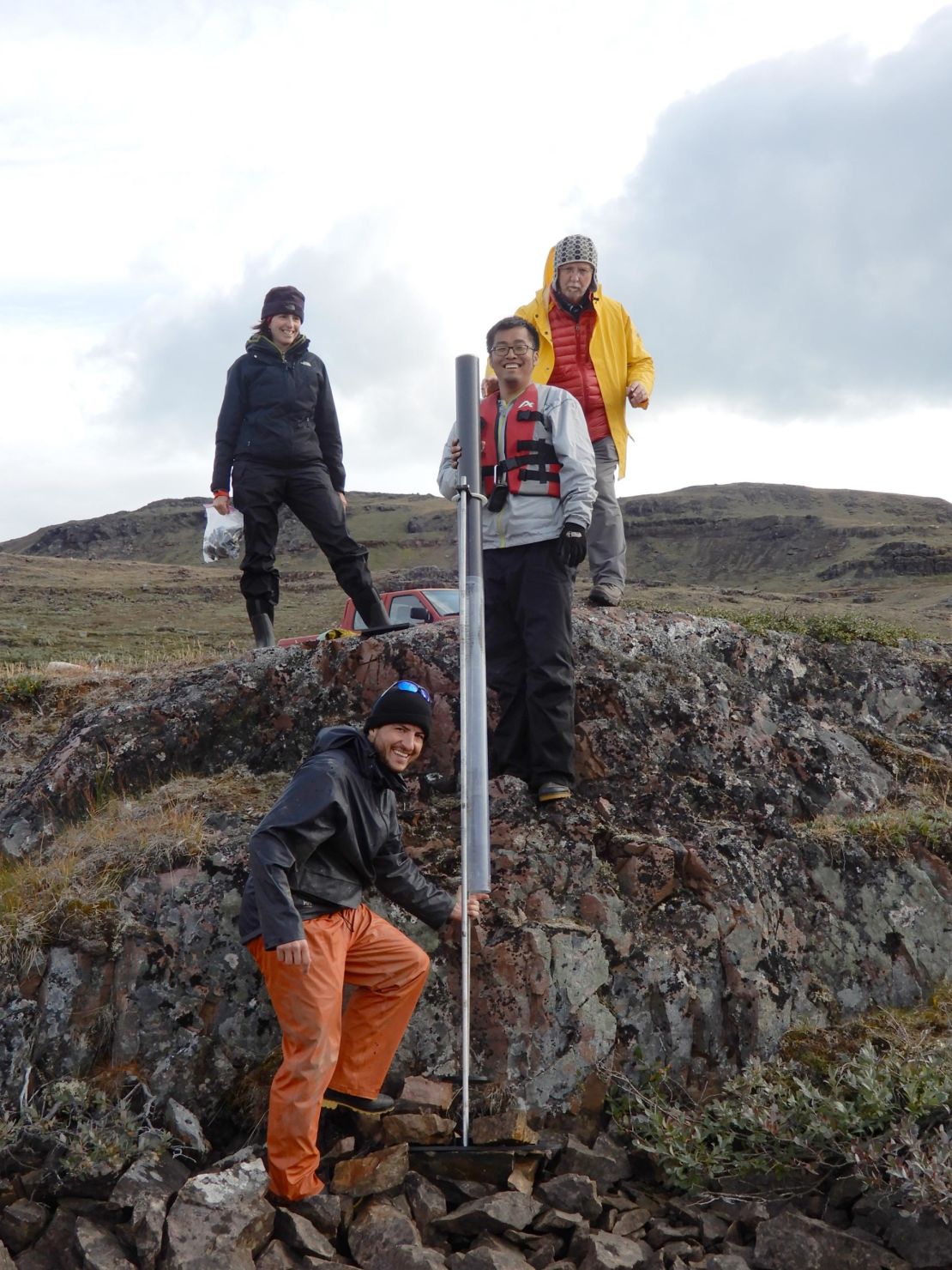 The research team, including (counterclockwise from left) Isla Castañeda, Tobias Schneider, Boyang Zhao and Raymond Bradley, are seen collecting lake sediment cores in southern Greenland.