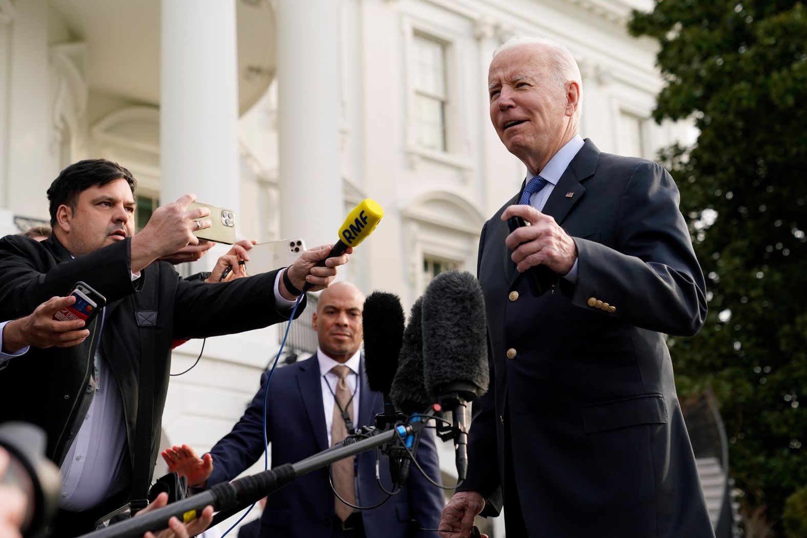 Biden speaks with members of the press before boarding Marine One on Wednesday. Asked what he'd say to his partners in Europe, Biden said he'd wait to deliver his message face to face.