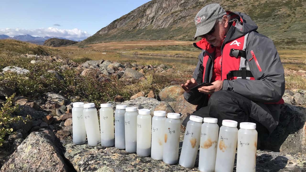 Bradley is pictured with some of the sediment samples the team collected from Lake Igaliku.