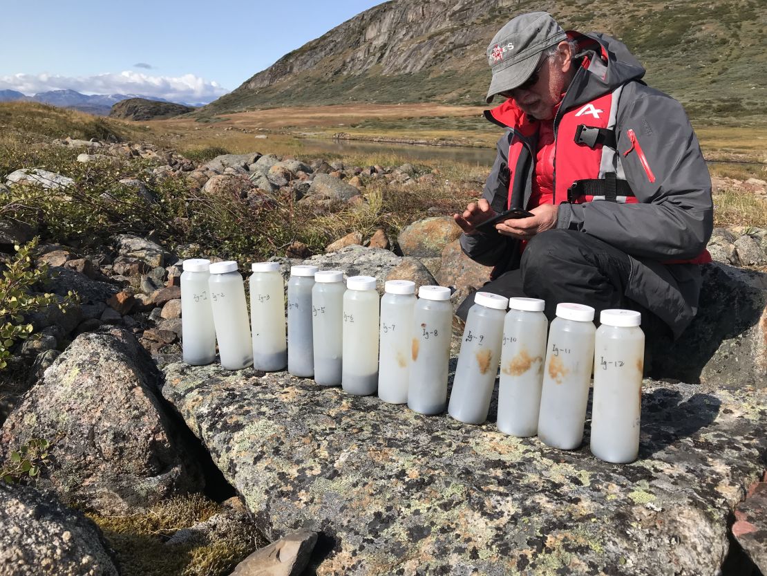Bradley is pictured with some of the sediment samples the team collected from Lake Igaliku.
