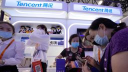 A woman holds up a soft toy at the Tencent booth during the China International Fair for Trade in Services (CIFTIS) in Beijing Monday, Sept. 6, 2021. Beijing has launched anti-monopoly and data security crackdowns to tighten control over internet giants including e-commerce platform Alibaba Group and games and social media operator Tencent Holdings Ltd. that looked too big and potentially independent.(AP Photo/Ng Han Guan)