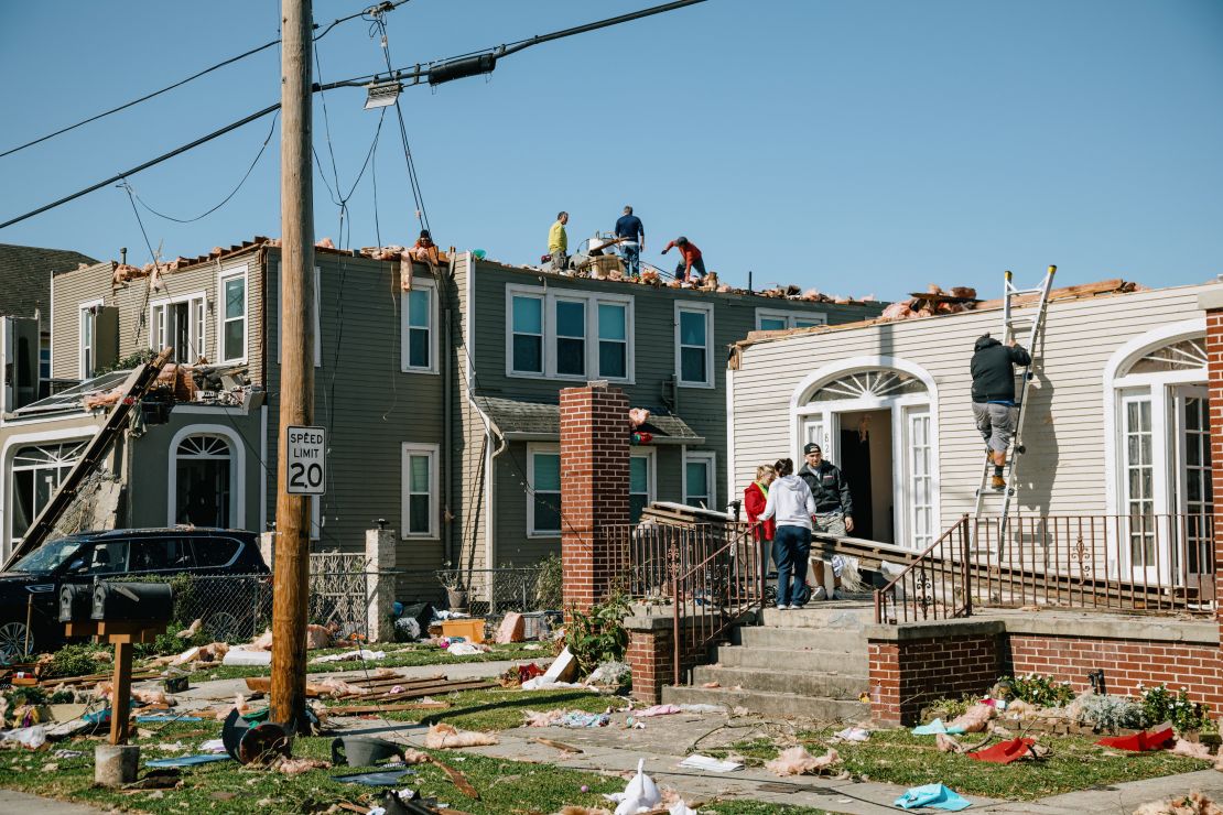 Residents assess damage to homes in Arabi, Louisiana, Wednesday.