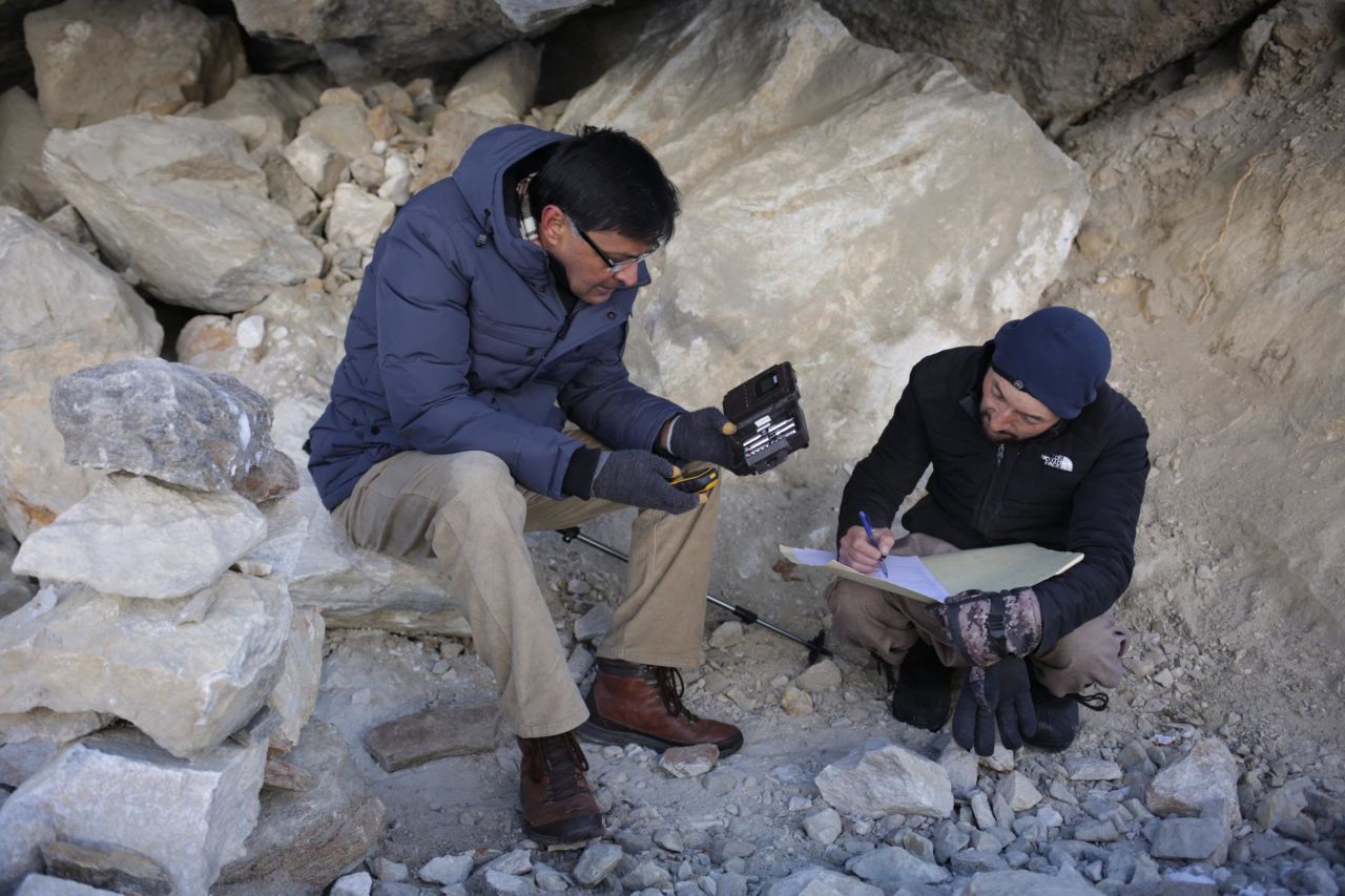 Hussain and his assistant, Sakhawat Ali, collect data from a camera trap installed to track snow leopards in their habitat near Hushe village.