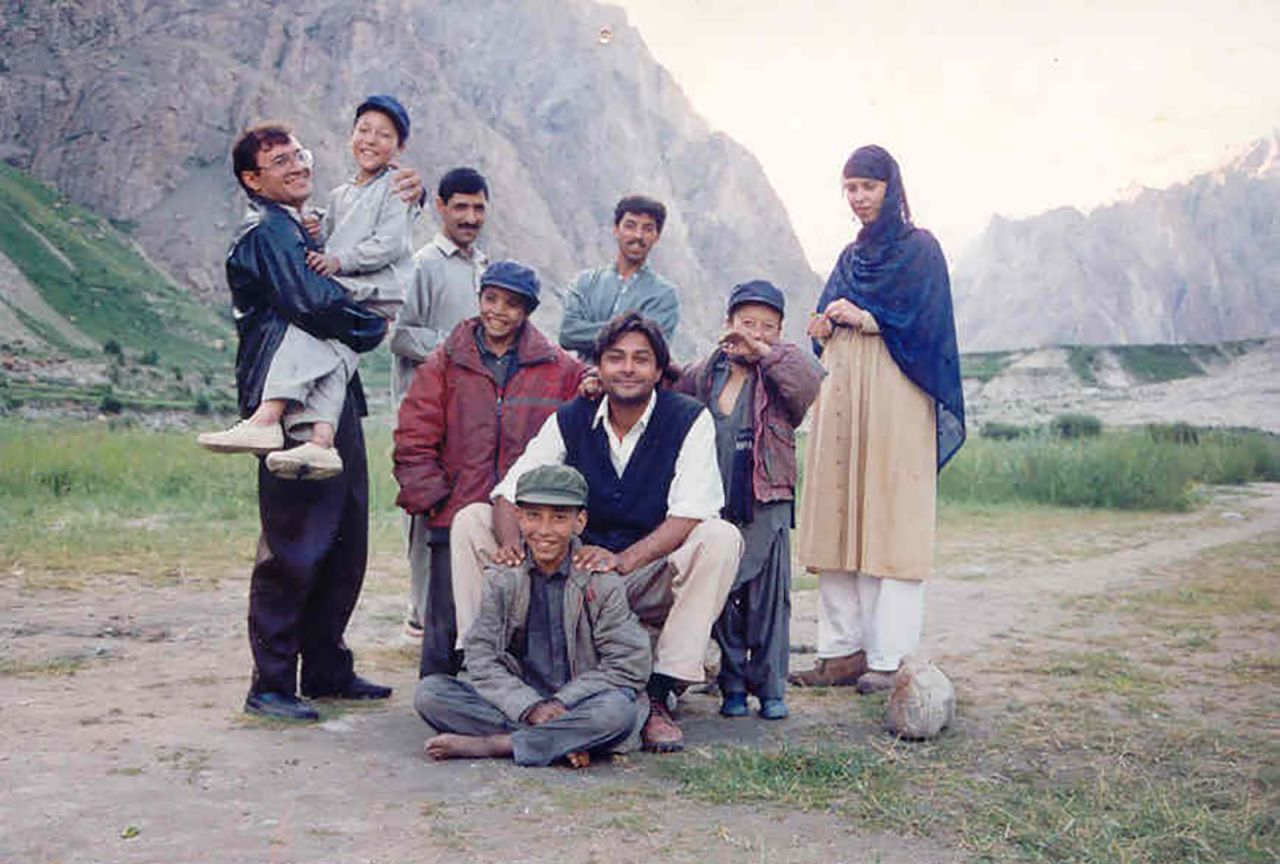 Hussain (center) has been working with local communities in the region for over two decades. This photo taken in 1995 shows him with his colleagues and their children. The boy carried (left) has now become his assistant (see next photo). Hussain says building relationships with people is essential to maintaining conservation work in the long term.
