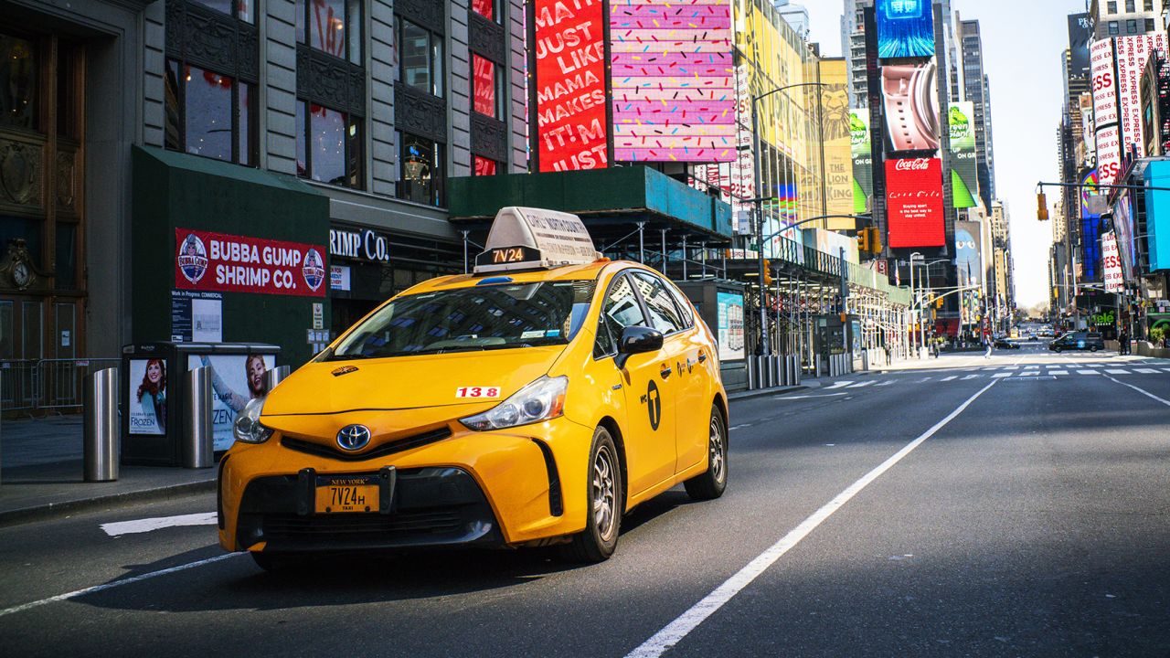 A taxi drives down Times Square on March 26, 2020 in New York City. 