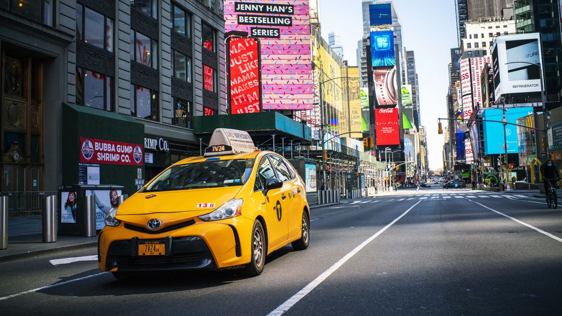 A taxi drives down Times Square on March 26, 2020 in New York City. 