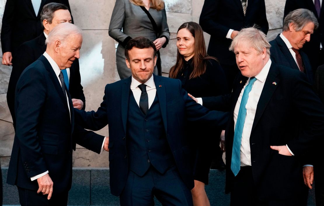 US President Joe Biden, Macron and British Prime Minister Boris Johnson speak prior to a group photo during a NATO summit in Brussels on March 24, 2022.