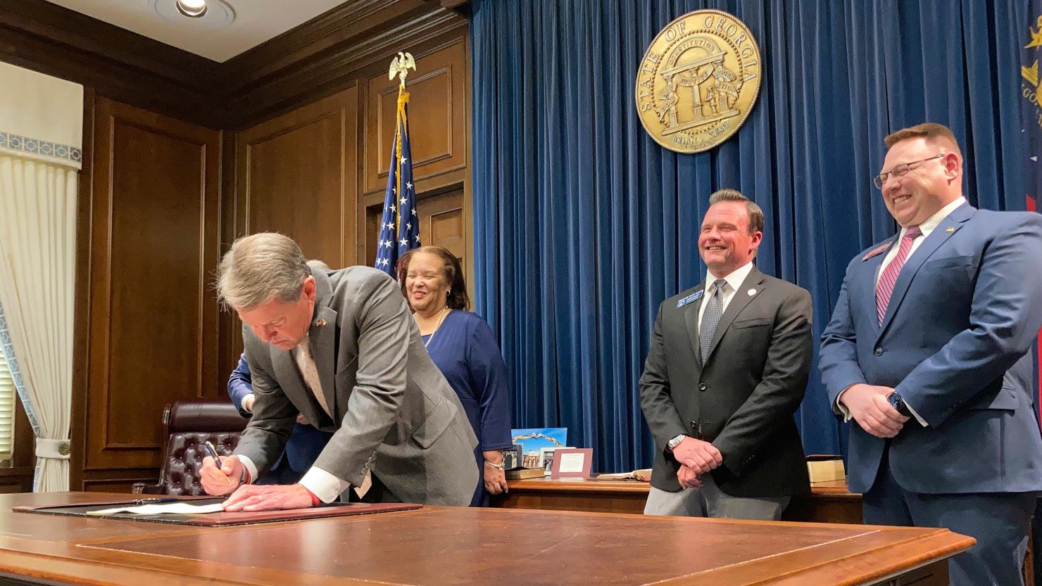 Georgia Gov. Brian Kemp signs a bill at the state Capitol in Atlanta on March 23, 2022, that will give income tax refunds of more than $1.1 billion to some Georgians.