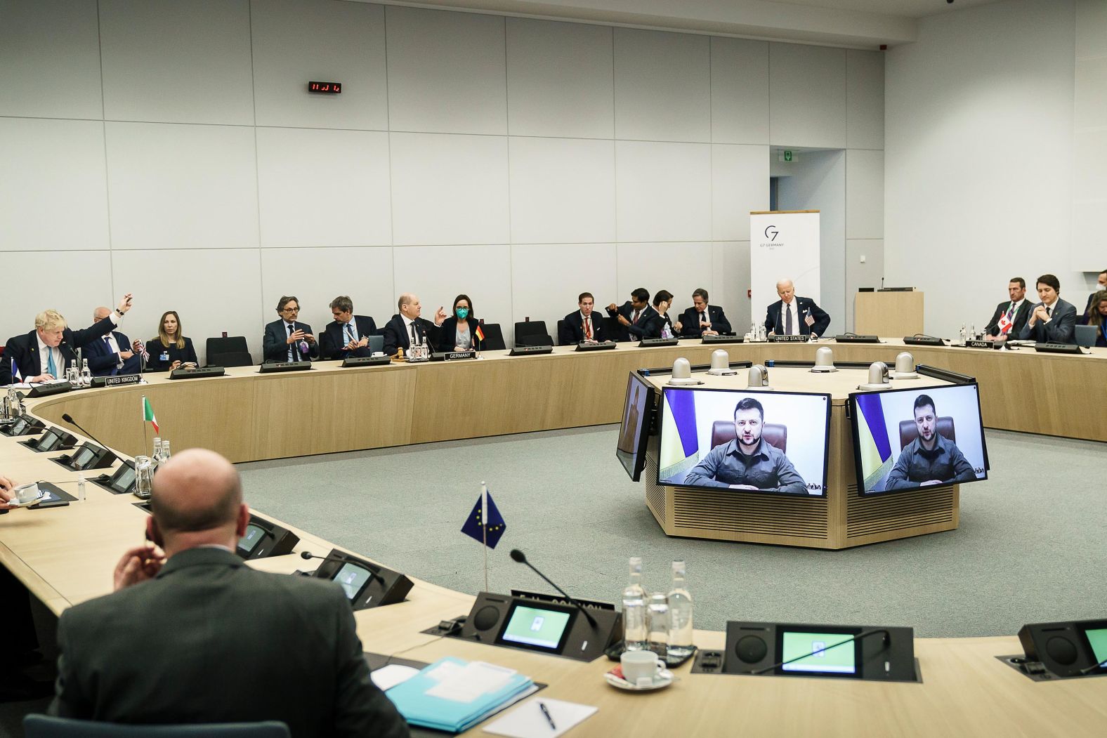 Ukrainian President Volodymyr Zelensky addresses Biden and other world leaders via video at the NATO summit in Brussels on Thursday. Zelensky stopped short of issuing his usual request for a no-fly zone, but he did say Ukraine needs fighter jets, tanks and better air defenses.