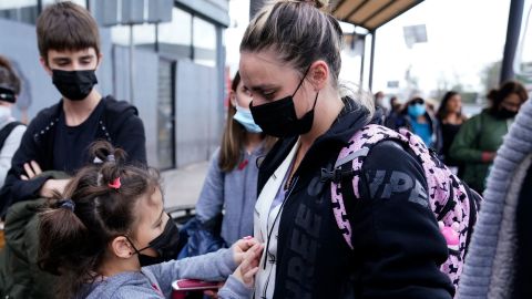 A woman from Ukraine stands with her children before crossing into the United States. U.S. authorities allowed the woman and her three children to seek asylum on March 10, a reversal from a day earlier when she was denied entry.