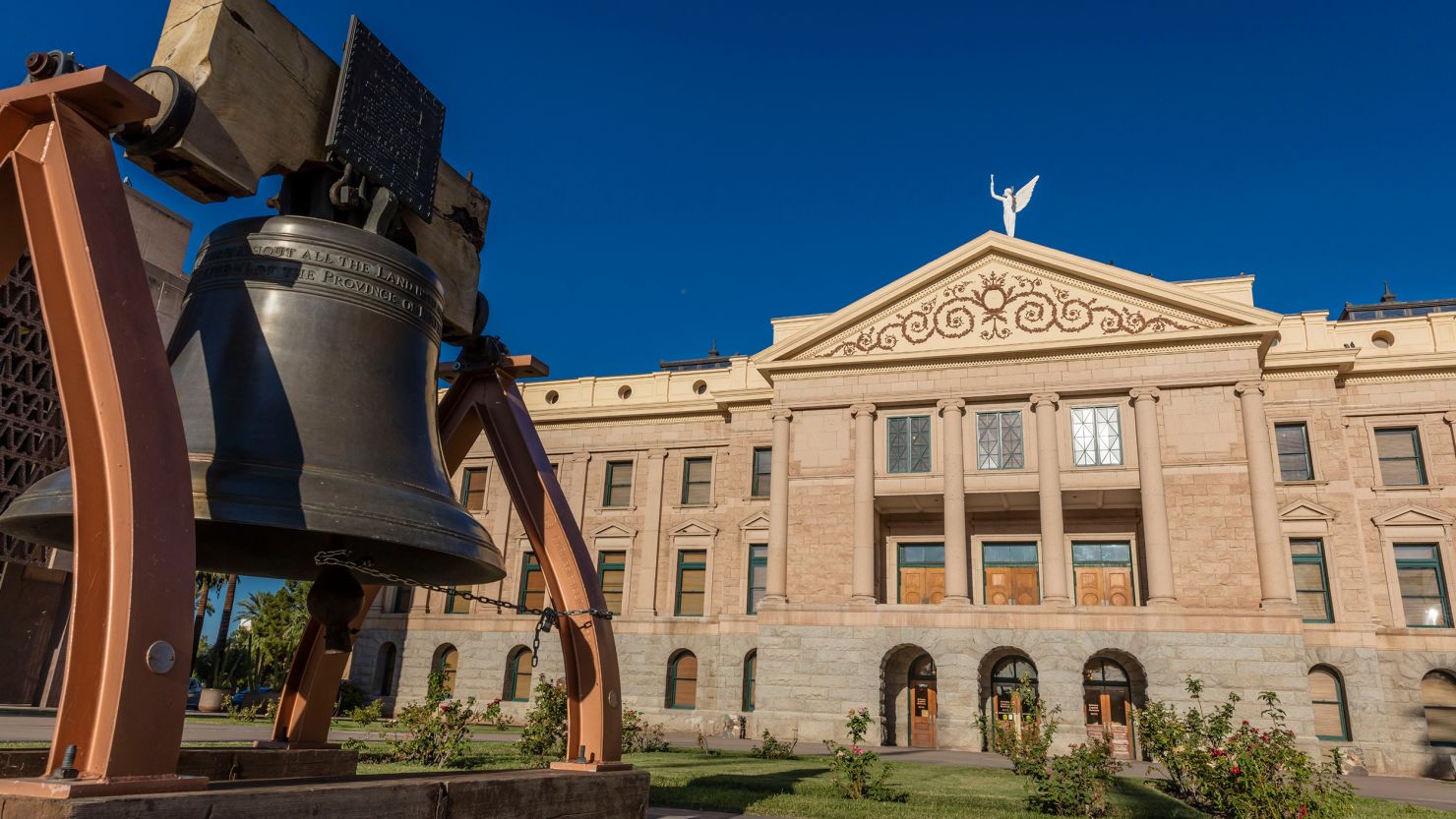 A replica of the Liberty Bell in front of the Arizona State Capitol Building.