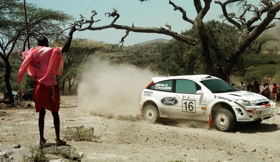 A Maasai warrior watches Petter<strong> </strong>Solberg and Phil Mills compete in the first leg of the 2000 <a href="https://www.ewrc-results.com/entryinfo/110-sameer-safari-rally-kenya-2000/7159/" target="_blank" target="_blank">Sameer Safari Rally</a>, south of Nairobi. The Norwegian and Briton would finish fifth in the three-day World Rally Championship event.