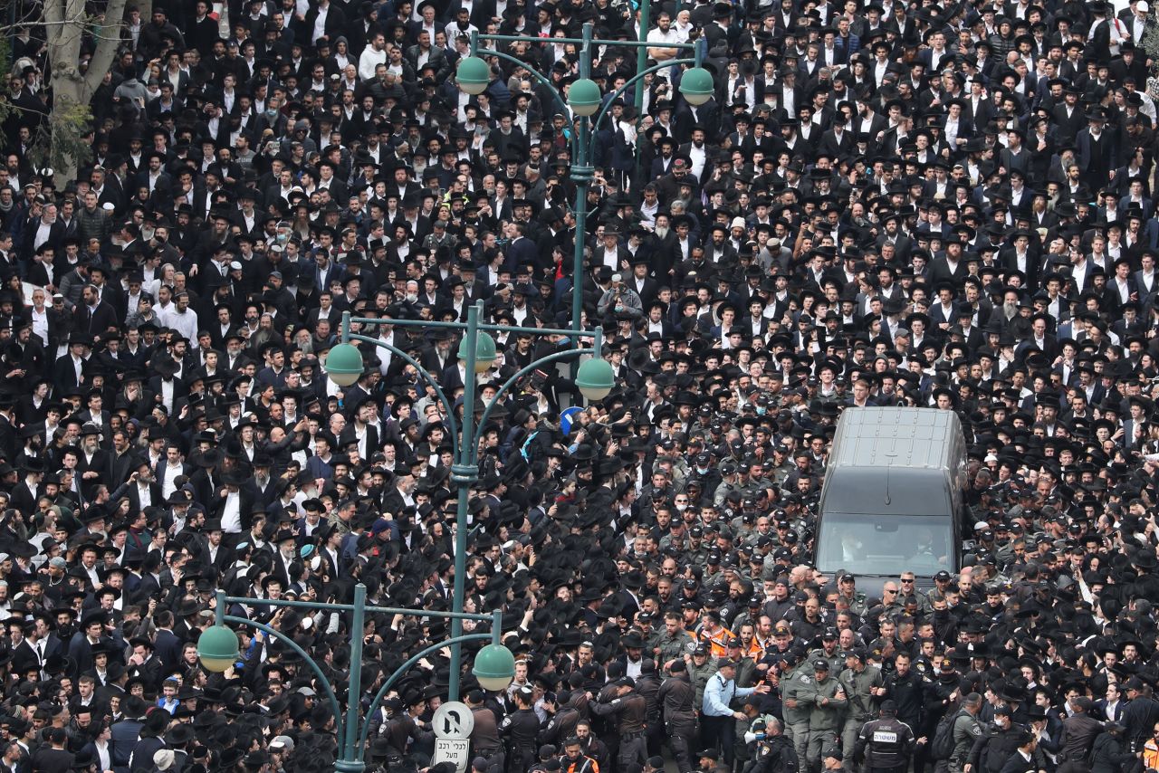 Thousands of ultra-Orthodox Jews escort the vehicle carrying the body of Rabbi Chaim Kanievsky during his mass funeral in Bnei Brak, Israel, on Sunday, March 20.