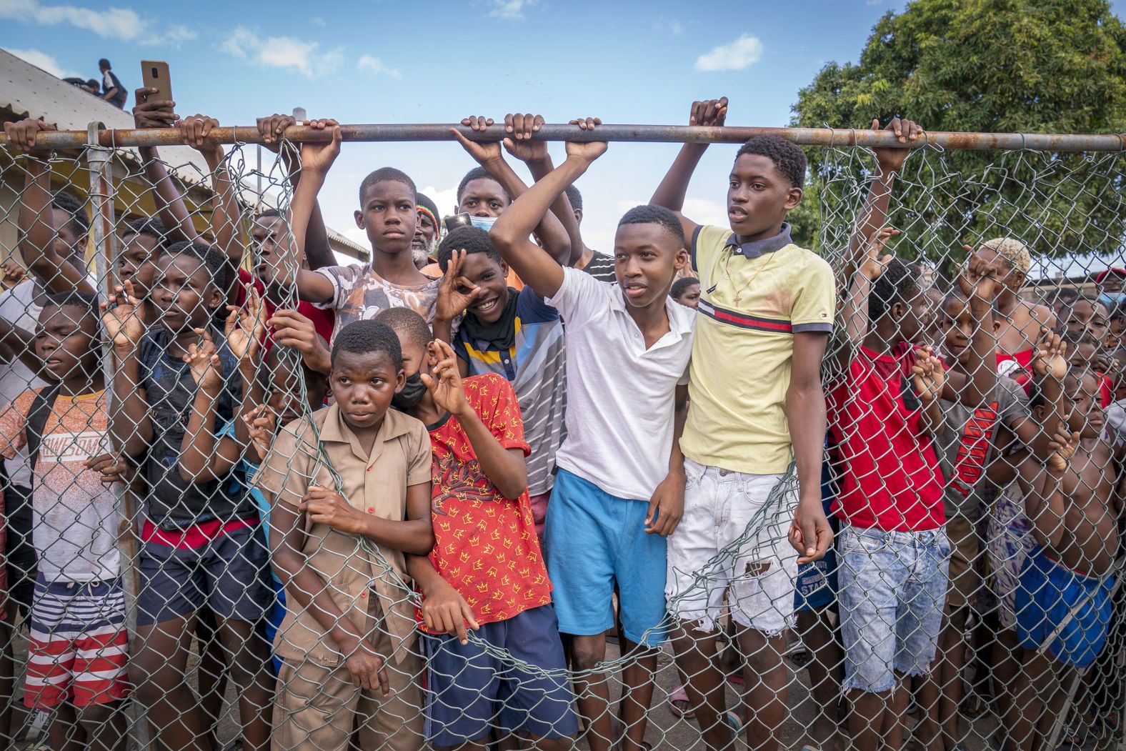 Children in Kingston, Jamaica, wait to catch a glimpse of Britain's Prince William and his wife Catherine, the Duchess of Cambridge, on Tuesday, March 22. The couple was on a <a href="index.php?page=&url=https%3A%2F%2Fwww.cnn.com%2F2022%2F03%2F23%2Famericas%2Fwilliam-kate-caribbean-royal-tour-intl%2Findex.html" target="_blank">weeklong tour of the Caribbean,</a> visiting Belize, Jamaica and the Bahamas for a series of engagements to celebrate Queen Elizabeth's platinum jubilee.