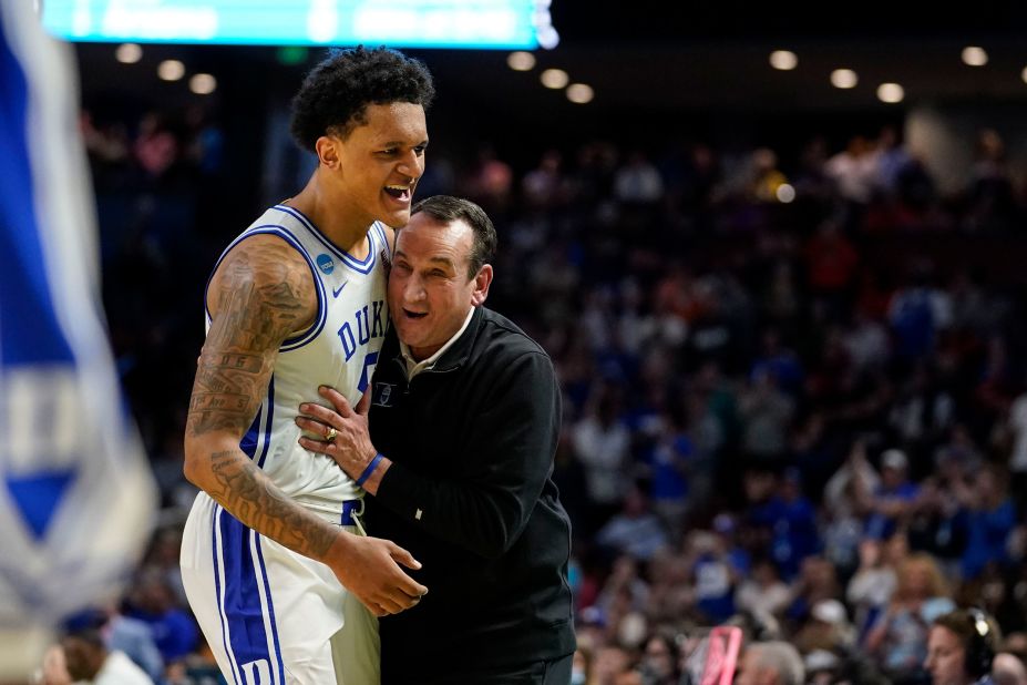 Krzyzewski is hugged by star freshman Paolo Banchero after Duke won their second-round game in the NCAA Tournament this year.