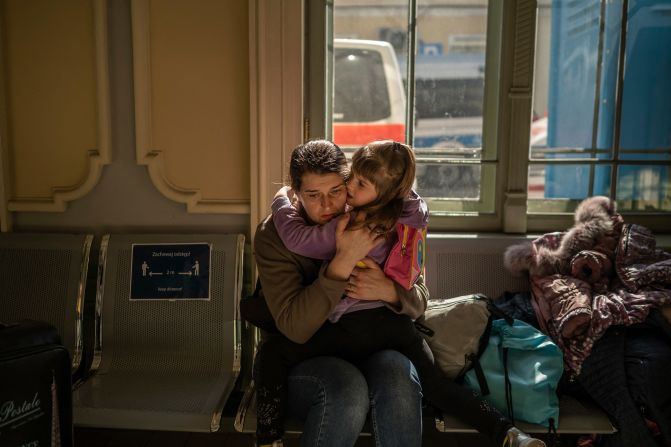 <strong>Shattered lives: </strong>A Ukrainian evacuee hugs a child in the train station in Przemysl, Poland.