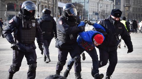 Police officers detain a man during a protest against Russia's invasion of Ukraine in Moscow on March 13, 2022.