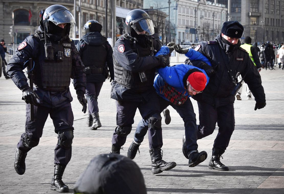 Police officers detain a man during a protest against Russia's invasion of Ukraine in Moscow on March 13, 2022.