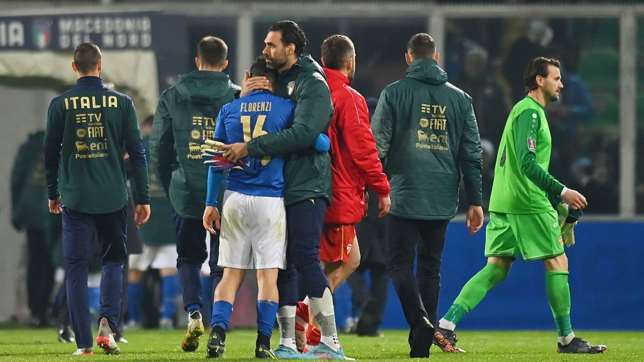 Alessandro Florenzi is consoled following defeat against North Macedonia.