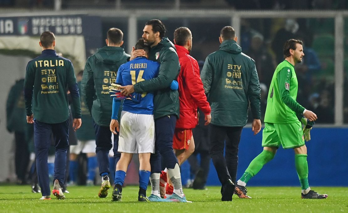 Alessandro Florenzi is consoled following defeat against North Macedonia.