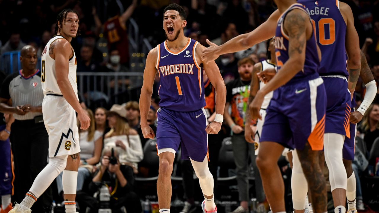 Devin Booker lets out a primal roar after he grabbed an offensive rebound for a putback, while drawing a foul against the Denver Nuggets.