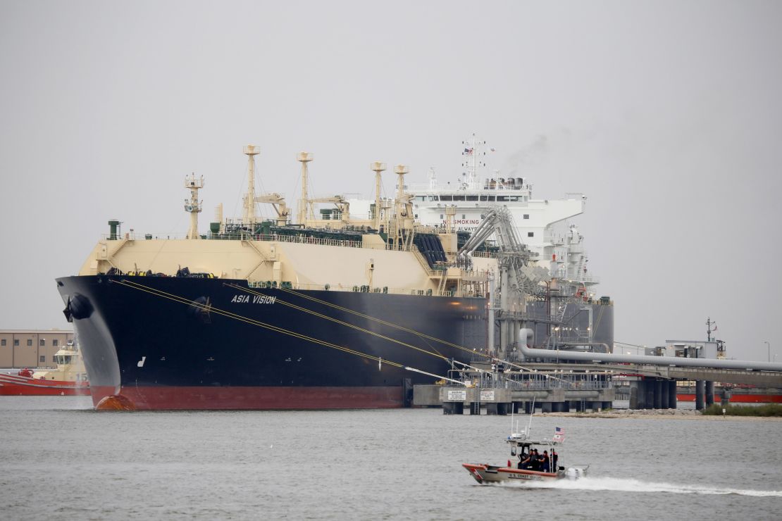 A US Coast Guard boat moves past the Asia Vision LNG carrier ship docked at a terminal in Sabine Pass, Texas.