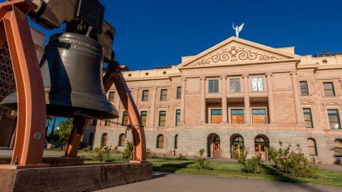 PHOENIX ARIZONA, Replica of Liberty Bell in front of Arizona State Capitol Building at sunrise. (Photo by: Joe Sohm/Visions of America/Universal Images Group via Getty Images)