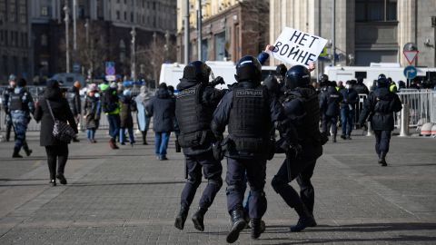 Police officers detain a man holding a placard reading "No to war" during a demonstration against Russian military action in Ukraine, in Manezhnaya Square, central Moscow on March 13.