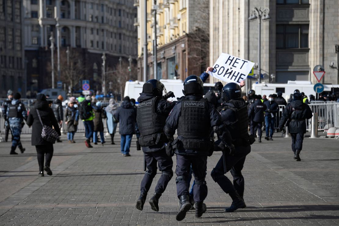 Police officers detain a man holding a placard reading "No to war" during a demonstration against Russian military action in Ukraine, in Manezhnaya Square, central Moscow on March 13.