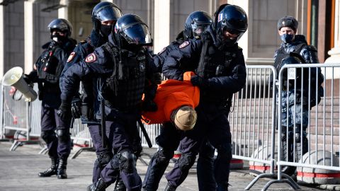 Police officers detain a man during a protest against Russian military action in Ukraine, in Manezhnaya Square in central Moscow on March 13, 2022. 